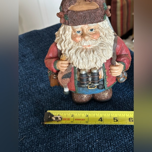 Hunting Santa carries his binoculars and hunting equipment wearing a furry hat - Picture 7 of 8